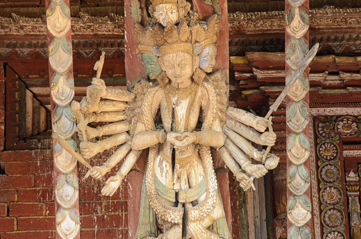 Kathmandu Changu Narayan 08 A Multi Armed Tantric Deity Carved In Wood On The Roof Strut On The South Side Of Changu Narayan Temple The roof strut on the south side of the Changu Narayan Temple in Kathmandu has an intricate carving of a multi-armed Tantric deity.